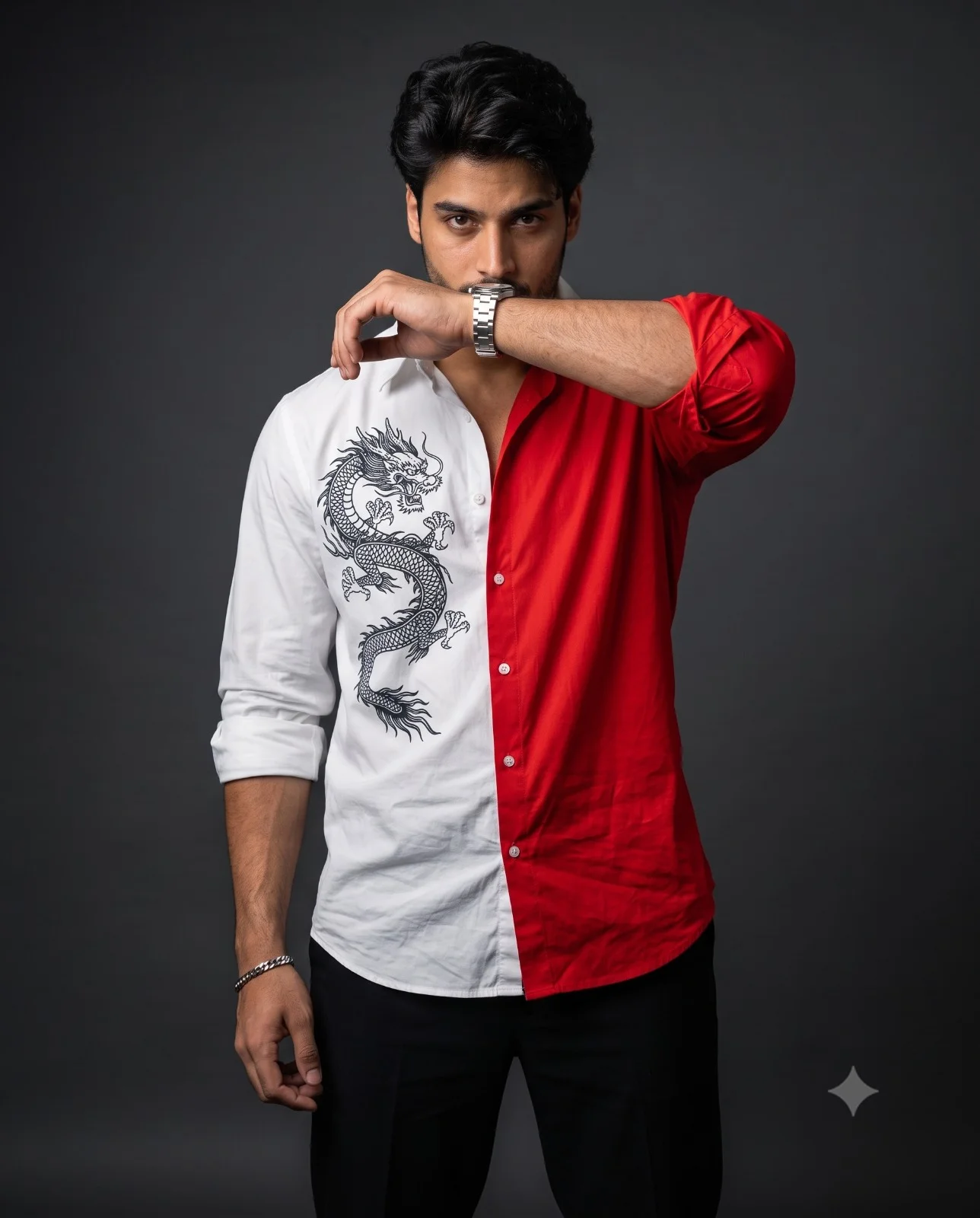 Man posing with his forearm across his mouth in a split red-and-white dragon shirt