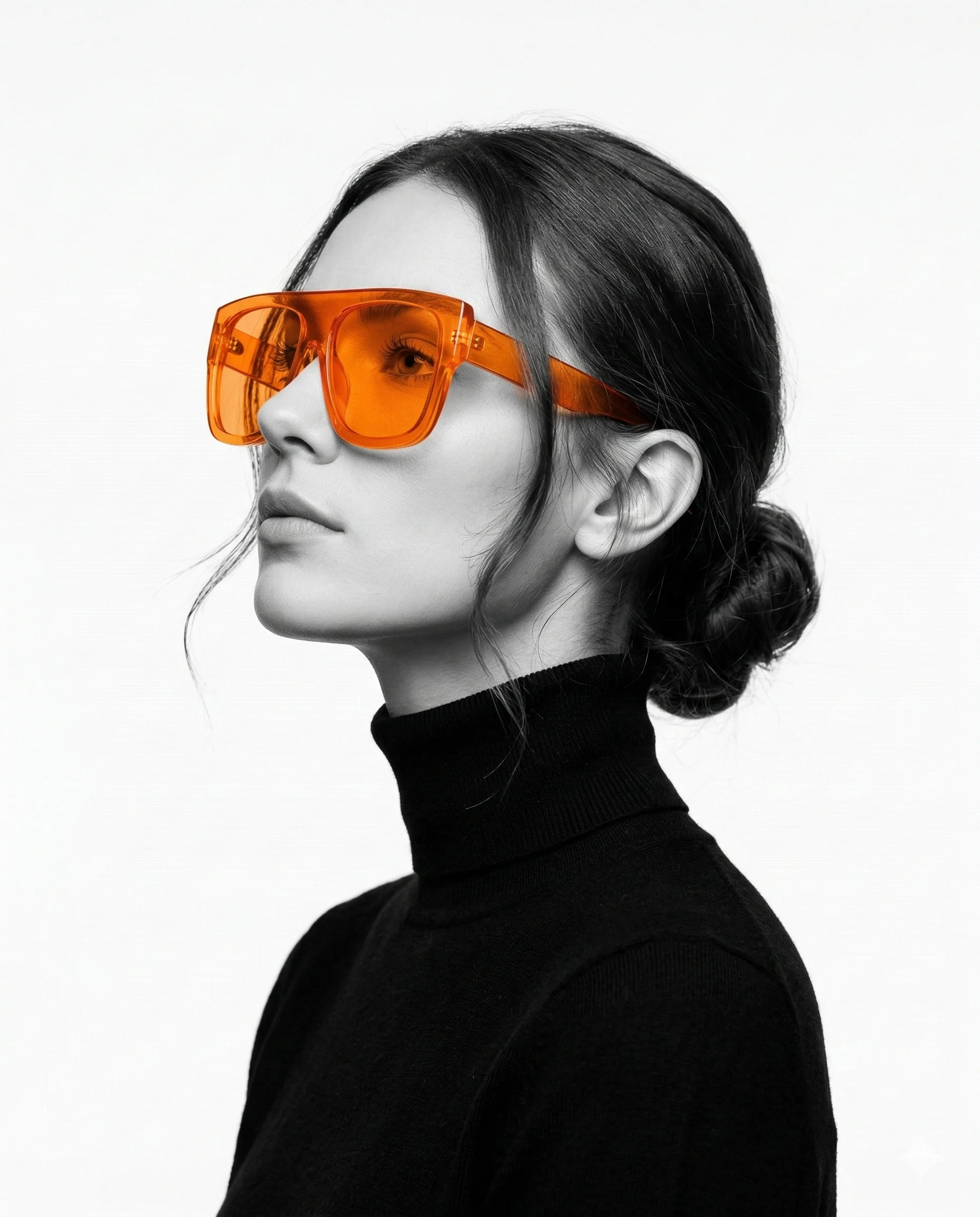 Woman in a black turtleneck wearing bright orange sunglasses